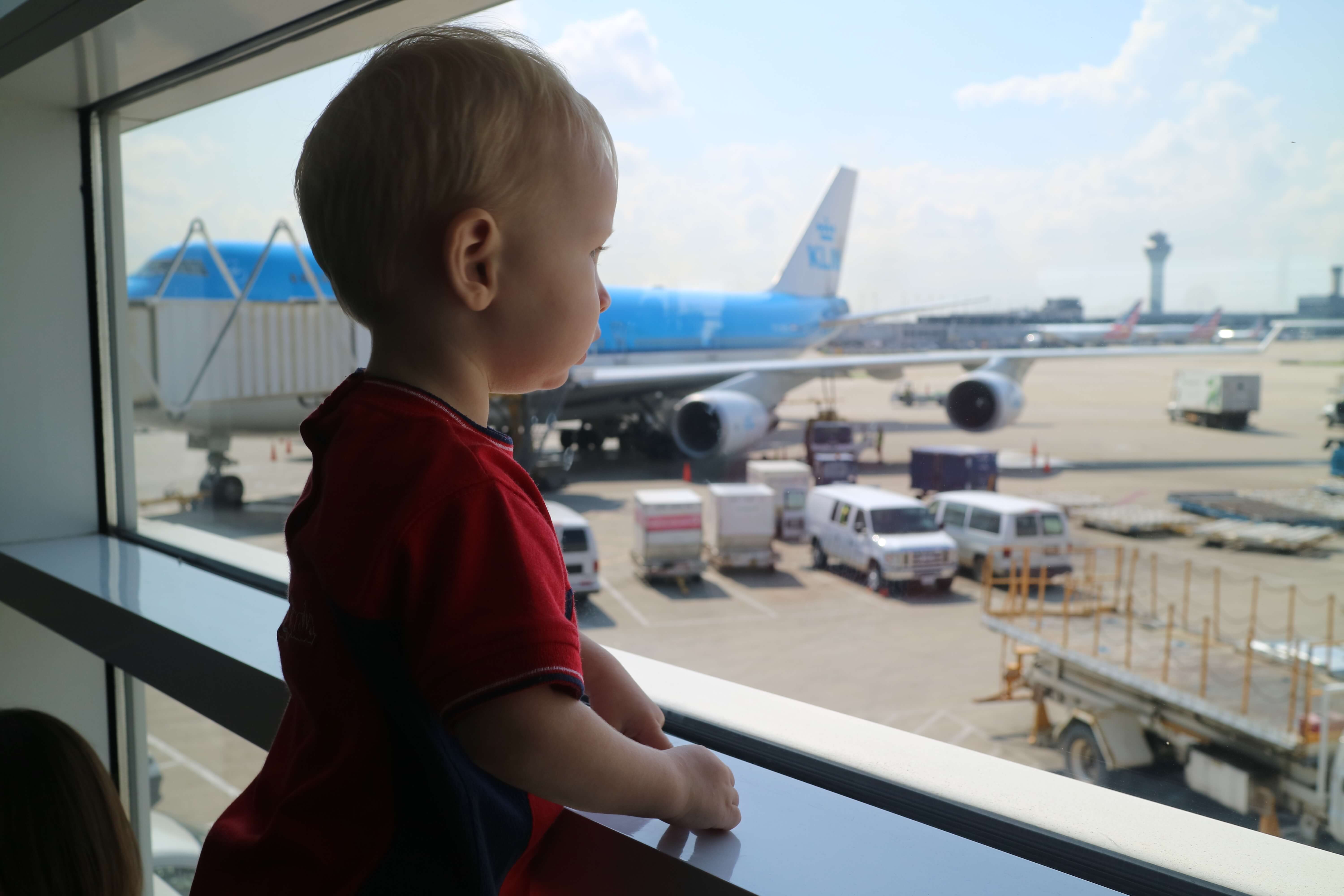 Benjamin looking out at the airplanes at the airport