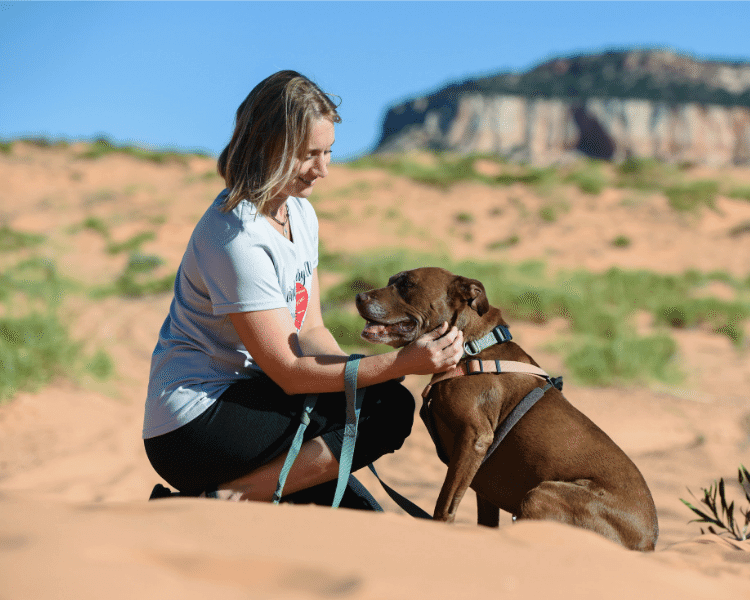 Best Friends woman volunteering to play with animals at Best Friends Animal Sanctuary
